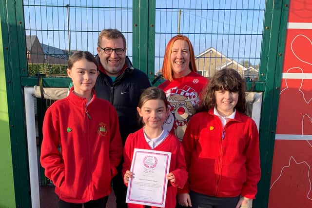 Palterton Primary School pupils pictured alongside Mr Whittaker, PE lead, and headteacher Mrs Horsley with the AfPE quality mark award