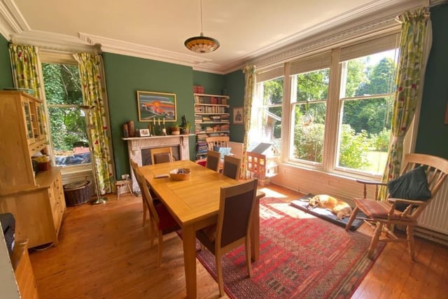 This bright and airy room has sash windows overlooking the rear garden, tall ceilings, a marble fireplace with open grate and stripped pine wood flooring.