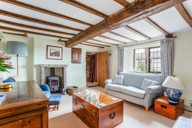 The sitting room has exposed oak beams and a stone fireplace with dual fuel burner and an original salt cupboard.