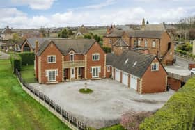A gravelled driveway and triple garage offers plenty of room for parking.