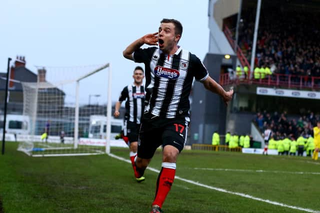 Ross Hannah celebrates scoring for Grimsby Town during an FA Cup Third round match against Huddersfield Town in 2014.  (Photo by Matthew Lewis/Getty Images)