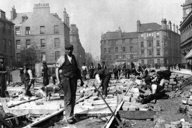 Construction workers lay down the original tram lines on Leith Walk in 1904.