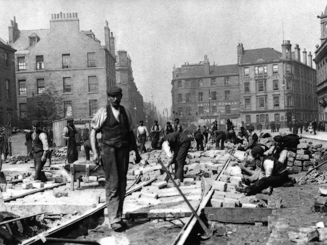 Construction workers lay down the original tram lines on Leith Walk in 1904.