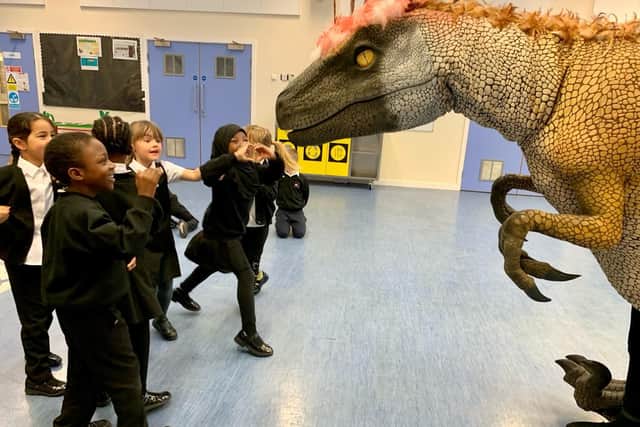 Year 1 pupils at The Bemrose School with one of the dinosaurs