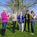 April Johnson, of the Community Unity Project, with Phoebe Mousley, Sandra Mousley, Oliver Mousley and Nicola Mousley dressed a tree with yellow hearts and ribbons at the Arc in Clowne to remember lives lost to Covid-19. Picture by Brian Eyre.