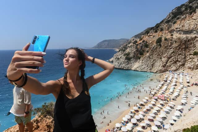 A woman poses for a selfie on Kaputas beach in Kas, Turkey. People can fly to Turkey from Doncaster Sheffield Airport without having to self-isolate when they return. Picture: Burak Kara/Getty Images.