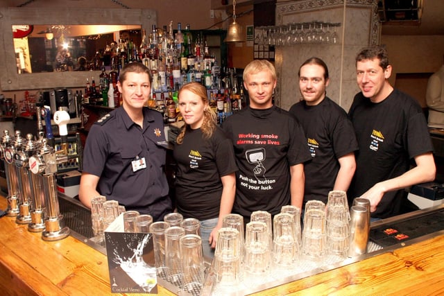 Roger Butler, owner of Chandlers bar and secretary of Pub Watch, with bar staff Gemma Jones, Matt James and Andrew Meakin and Steve Helps, manager at Chesterfield Fire Station in  2006.