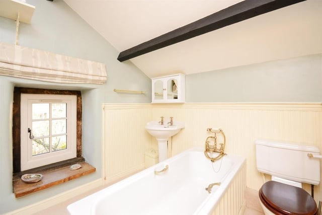 The family bathroom contains a bath with mixer tap shower overhead, wash basin and wc.