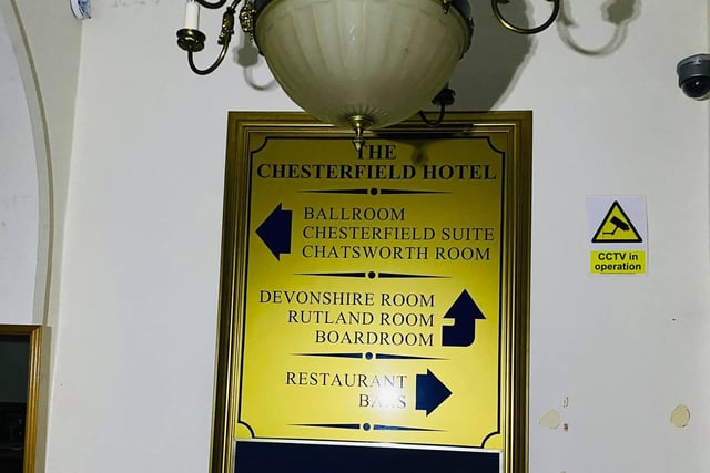 A sign giving directions inside the hotel.