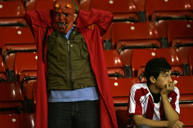 Two Dejected Blades fans after the third Arsenal goal