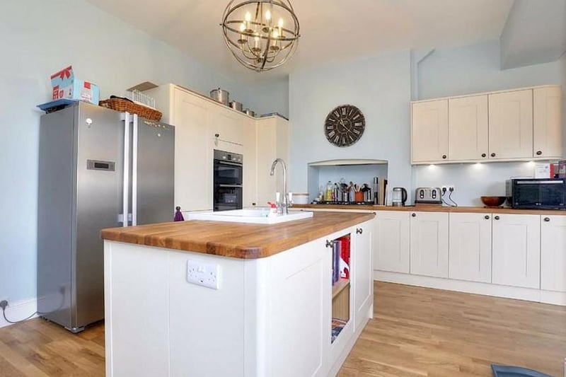 This is the kitchen - it contains a range of fitted units, solid wood worktops, and an island.