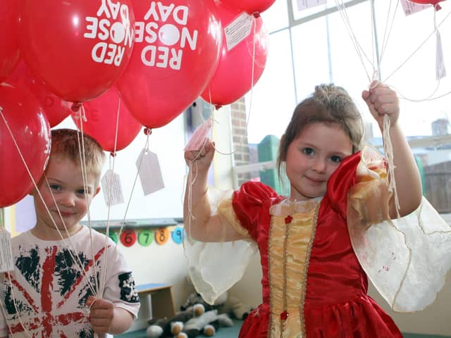 Jorge Marsden and Ruby Revell celebrate Red Nose Day with a balloon release at Cheeky Monkeys nursery in Chesterfield in  2011.