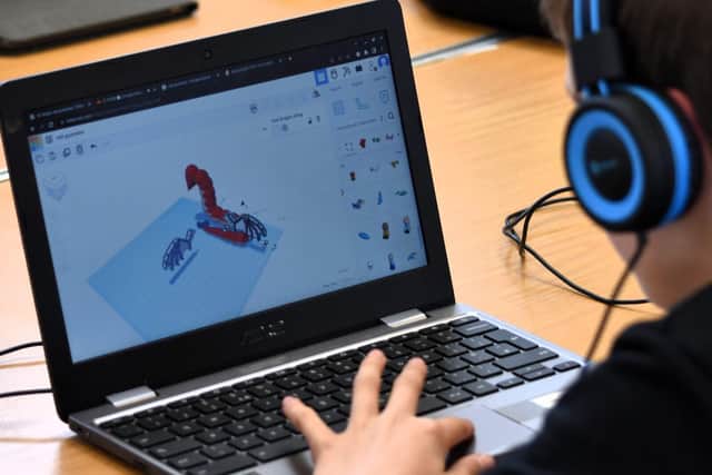 Child using 3D technology to create his own product and designs 
