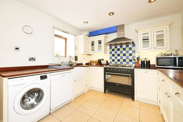 The well appointed kitchen includes a Belfast sink inset into the wooden work surface, with window above which looks out onto the rear garden. A range cooker is included in the sale of the property. The floor is tiled in natural limestone.