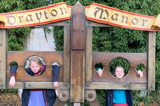 Jessica Ball, aged nine, and six-year-old Rebecca Ball in the stocks at Drayton Manor Theme Park.