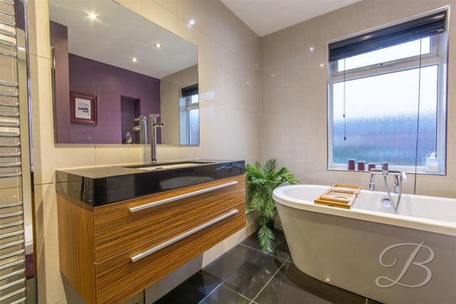 Complete with modern freestanding bath, low flush WC, vanity wash basin and enclosed shower.