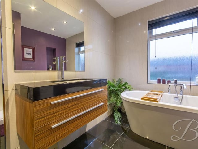 Complete with modern freestanding bath, low flush WC, vanity wash basin and enclosed shower.