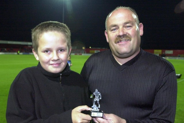 Bryan Rouse, aged 12, of Stainforth, receives a memento from Football in the Community officer Eric Randerson