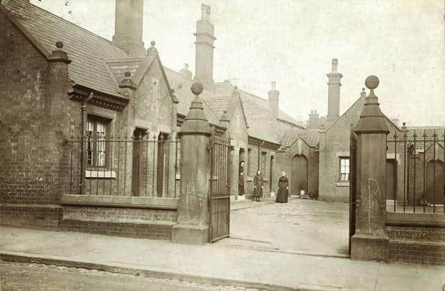 The almshouses were built in 1875 from a trust provided by the wills of Thomas Large, George Taylor and Sarah Rose. There were 11 houses, administered by the Chesterfield Municipal Trustees for 'poor persons of good character'. They were demolished in 1971 to allow a carpark to be available. The residents were rehoused in accommodation on St Helen's Close, Newbold Road. See also DCCC00569.