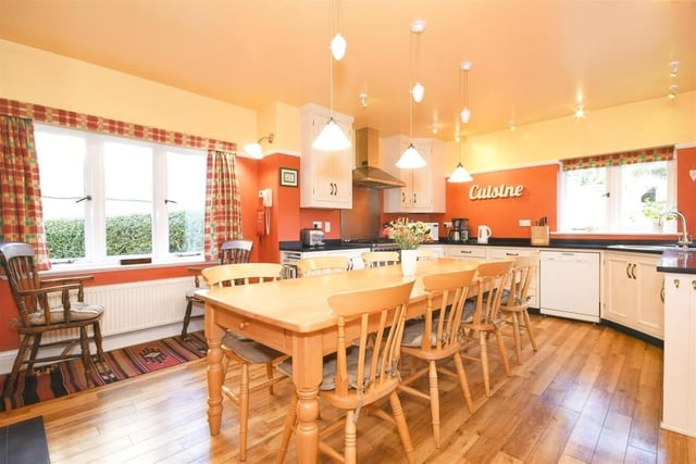 The bright and airy kitchen is large enough to accommodate a dining table and contains a log burner set in the original fireplace opening.