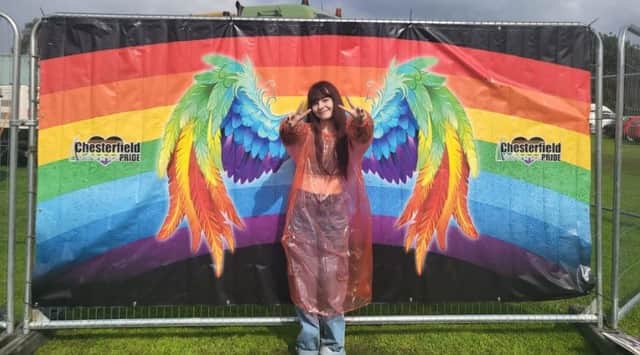 A visitor poses against a Chesterfield Pride banner backdrop in this photo submitted by Kirsty Haynes.