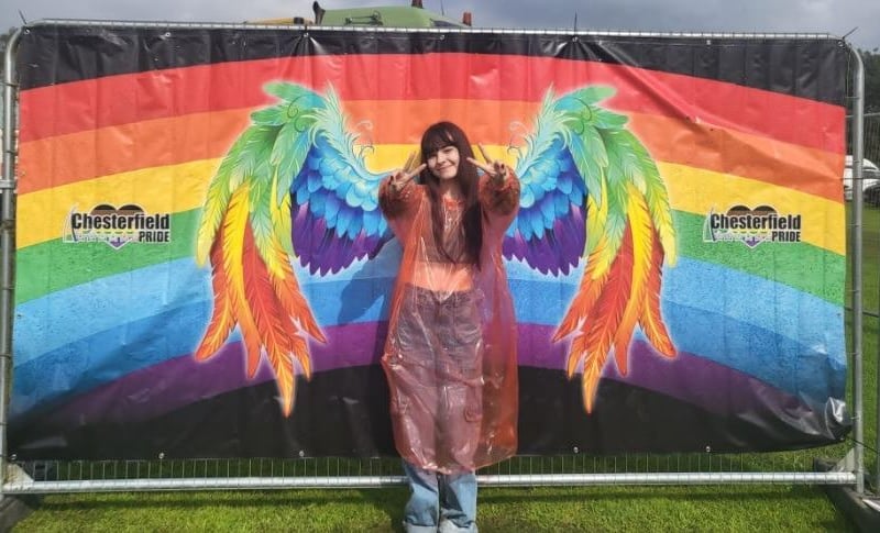 A visitor poses against a Chesterfield Pride banner backdrop in this photo submitted by Kirsty Haynes.