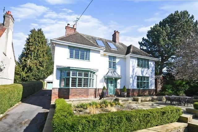 A driveway sweeps from the entrance on Brockwell Lane, passes through a large lawned area and then splits to give access to both the front of the house and the detached garage behind it.
