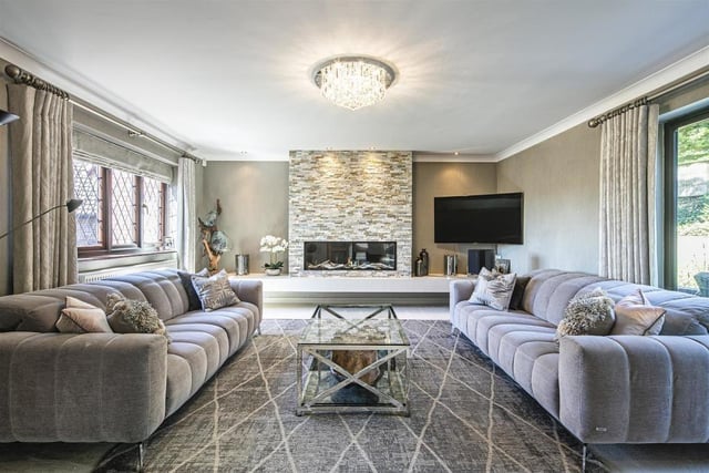 Just through from the dining space is this incredible lounge with masses of space for two large sofas, a big TV and a coffee table. The fireplace at the end of the room is absolutely stunning and shows the brilliance of this modern home.