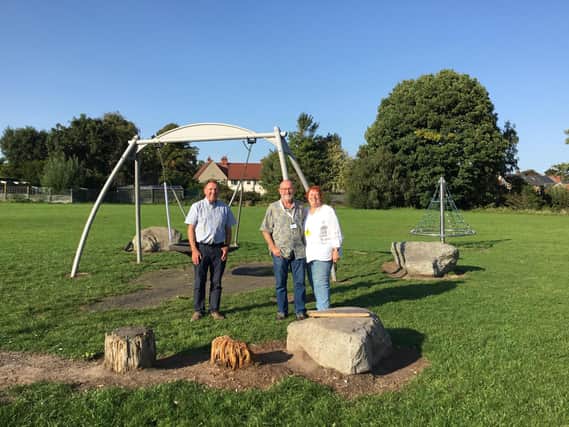 Councillors Howard Borrell, Paul Niblock and Shirley Niblock at the playground in Inkerman Park where a wooden log bench was destroyed and a swing deliberately damaged.