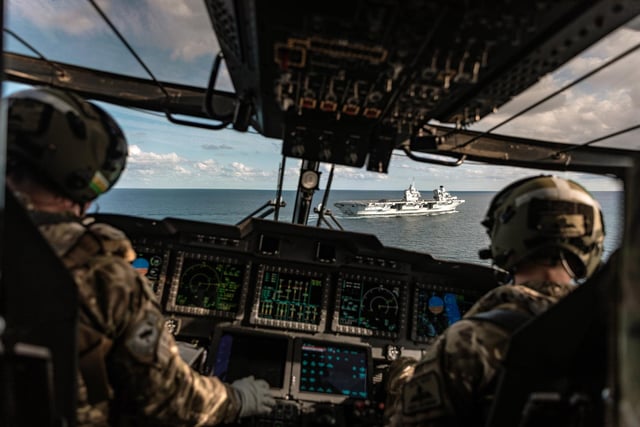 HMS Queen Elizabeth as seen through the cockpit of a Merlin helicopter before landing on the aircraft carrier during trials off the east coast of the USA. This image was part of the Peregrine Trophy winning selection from HMS Queen Elizabeth. By Leading Photographer Dan Shepherd