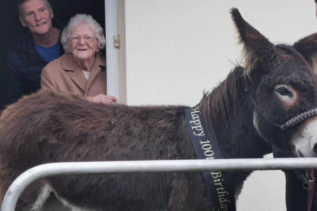 Ethel Griffin, with her son Shaun, is surprised by a four-legged visitor!