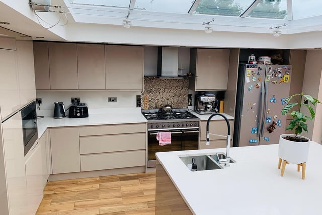 The kitchen has high gloss units with quartz stone worktops. There is also a quartz island, Smeg range oven with hob and extractor above, integrated dishwasher and microwave.