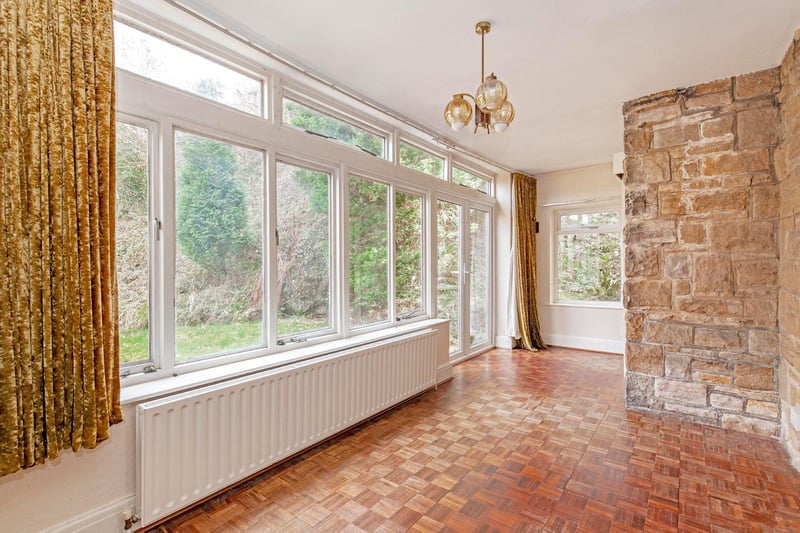 The house has three reception areas including a large lounge and garden room with parquet flooring.