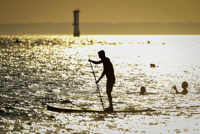 A stand up boarder in the evening sunshine on Southsea beach on September 21, 2020 in Portsmouth. Picture: Finnbarr Webster