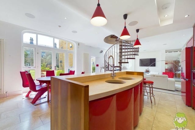 The kitchen offers plenty of space, with room for a dining table close by and views of the outside courtyard from large windows.