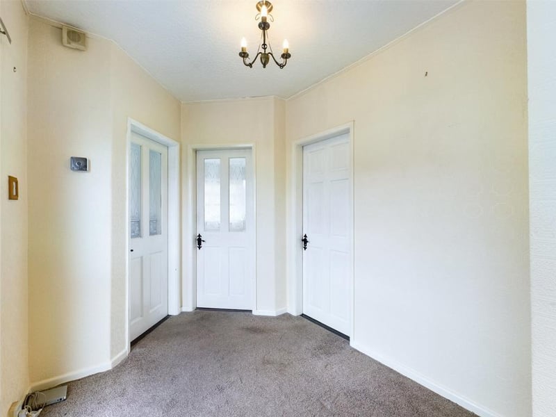 Spacious entrance hall with double glazed door and window.
