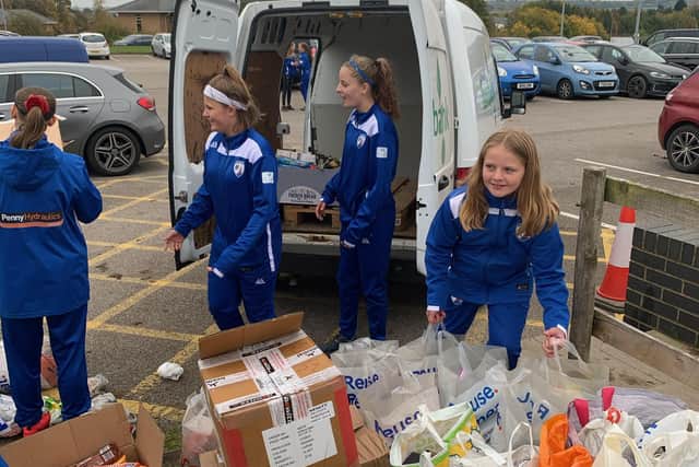 Junior members of Chesterfield FC Women helped to load the foodbank's van with the goods.