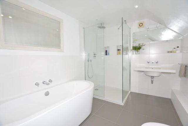 The contemporary en suite to the master bedroom comprises a double-ended bath, walk-in Bristan shower, wash hand basin and low-level WC. There's also a heated towel-rail, while the floor is tiled.