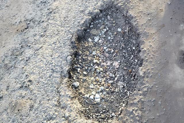 One taxi driver lost a tyre after hitting this pothole on the way to the farm.