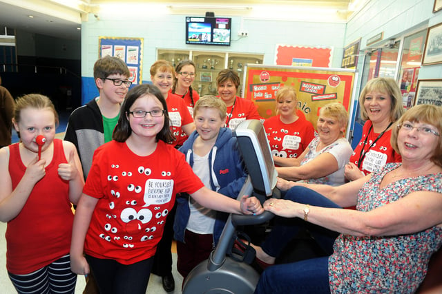 Staff and students from the Buxton Community School cheered on Stephanie Lund and Angela Ray during their stint on the exercise bike for which the school is collecting donations for a 514 mile 'ride' in aid of Comic Relief in 2015