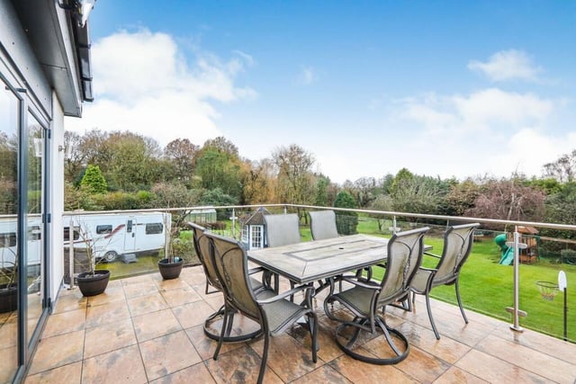 A snug, attached to the open-plan kitchen and dining area, has bi-folding doors that lead on to this fantastic balcony, which overlooks the gorgeous rear garden. It is an ideal spot for summer lunch.