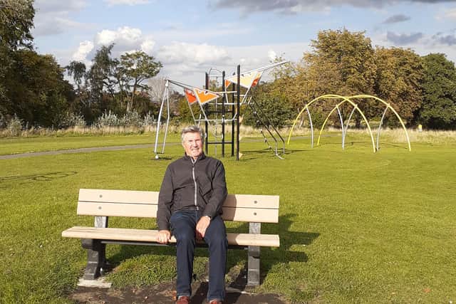 Councillor Ron Mihaly at Whitecotes Field playground, with new play equipment in the background.