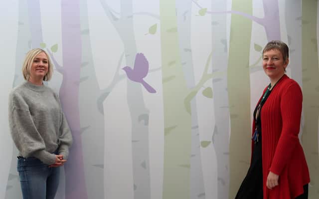 Artist Emma Duerden with the new designs in the wellbeing space at Treetops Hospice.