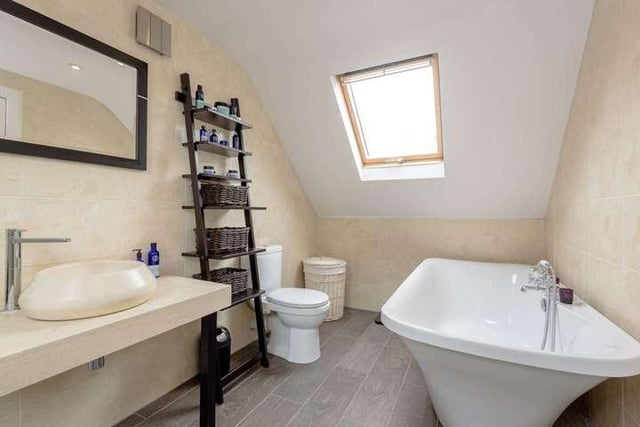 The master ensuite has a modern bath tub and is one of three bathrooms in the property.