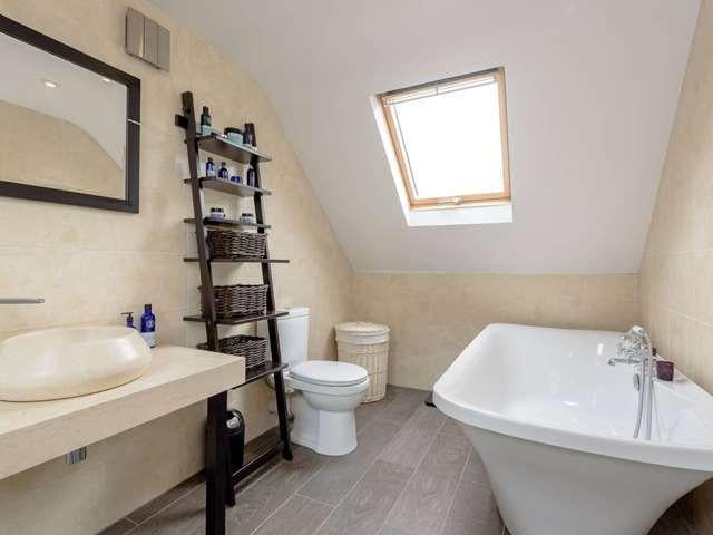 The master ensuite has a modern bath tub and is one of three bathrooms in the property.