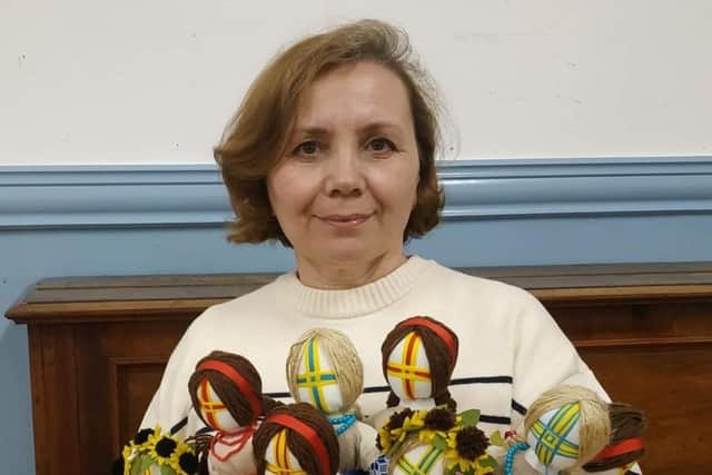 Iryna Zaiarna, 55, with a collection of her handmade motanka dolls.