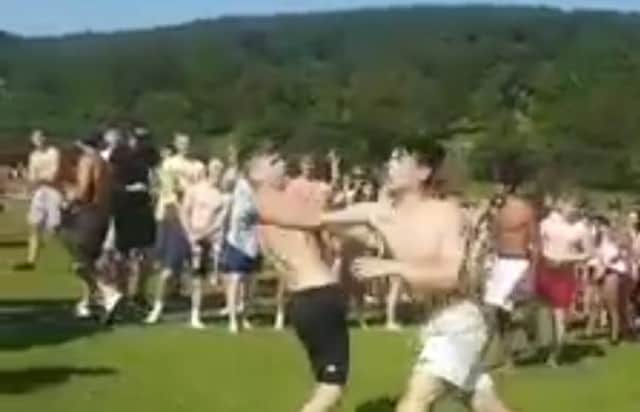 Two youths were filmed fighting as huge crowds gathered at Chatsworth in the Peak District