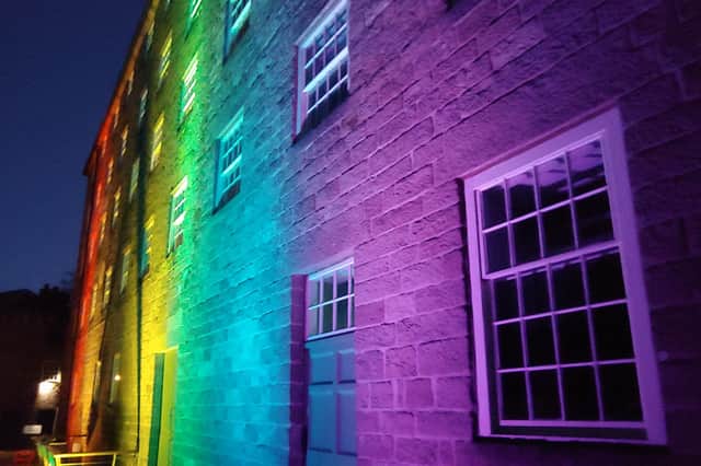 Cromford Mills lit up one of its buildings in rainbow lights