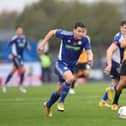 Connor Dimaio runs with the ball during the Emirates FA Cup First Round match between Curzon Ashton and Cambridge United  at Tameside Stadium. (Photo by Nathan Stirk/Getty Images)