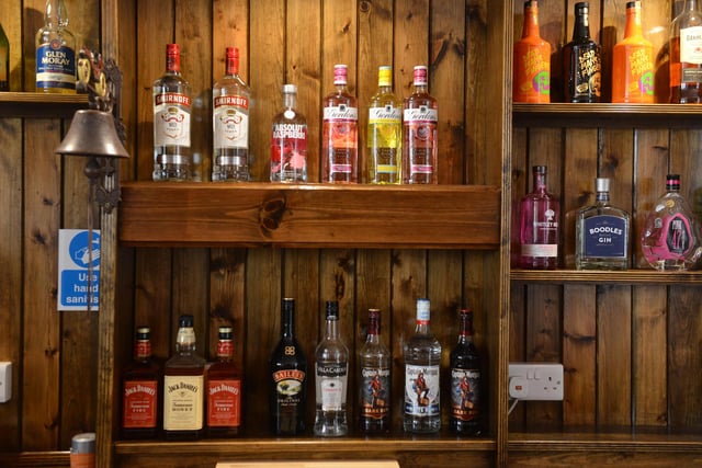 A range of spirits on offer behind the bar - and hand sanitiser stations to keep staff and customers safe.